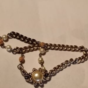 A double chained bracelet with reversible pendent
